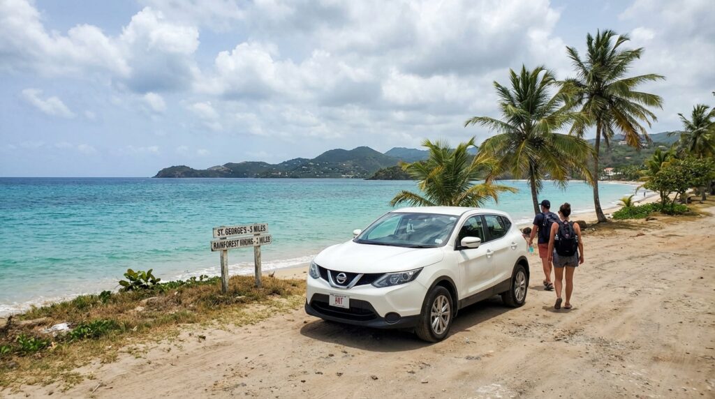 Rental car parked at a beautiful Grenada beach, highlighting easy access to the island’s top attractions like beaches and hiking trails.