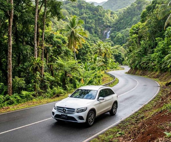 SUV driving through scenic inland routes with car rental Grenada for spice plantations connecting nature and hillside roads